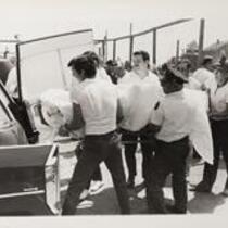 Stretcher being loaded into vehicle after Allegheny Airlines [Flight 485] plane crash, East Haven, June 7, 1971